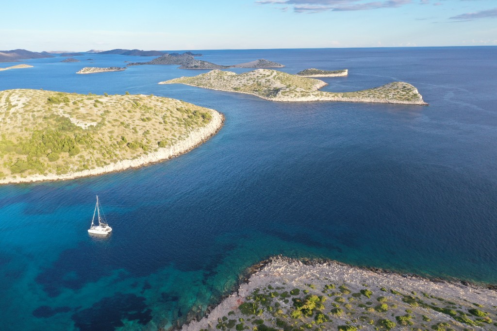 Yacht at anchor in a turquoise bay